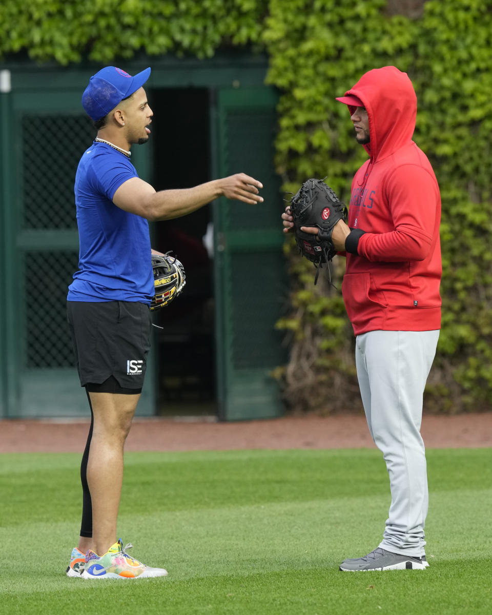 St. Louis Cardinals' Willson Contreras, right, visits with former teammate Christopher Morel, who was just called up by the Chicago Cubs, before a baseball game Monday, May 8, 2023, in Chicago, Contreras returned to Wrigley Field for the first time since leaving the Cubs after last season. (AP Photo/Charles Rex Arbogast)