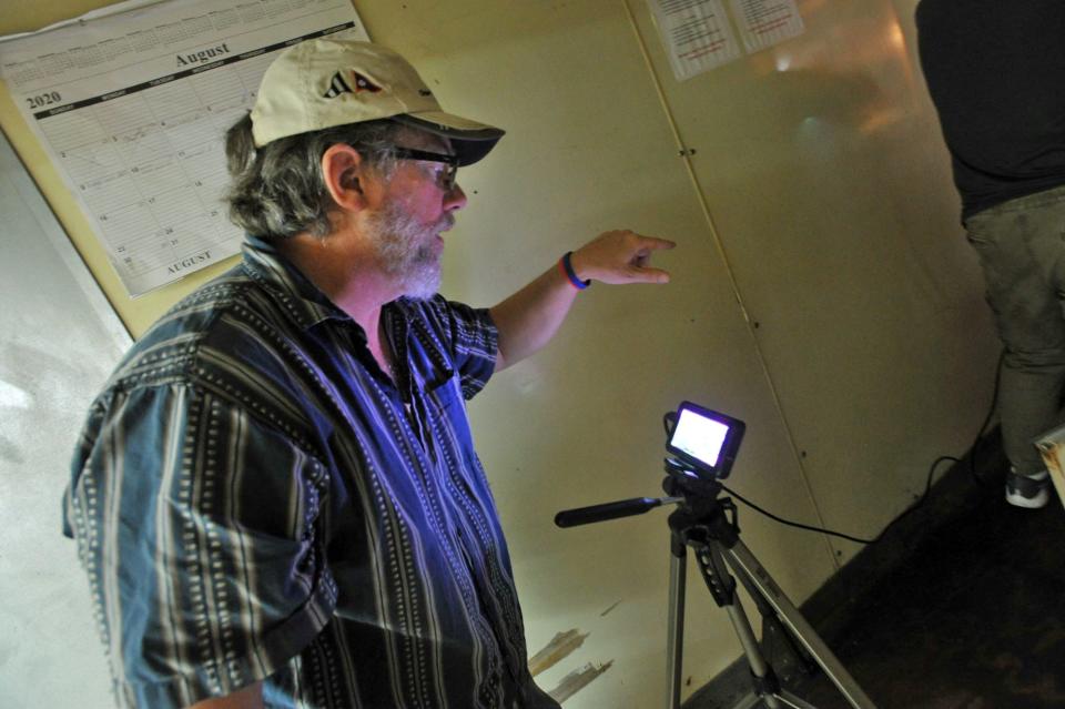 Director Jeff Long, of Newport, Rhode Island, gives instructions to his cast as he watches a scene on a monitor.