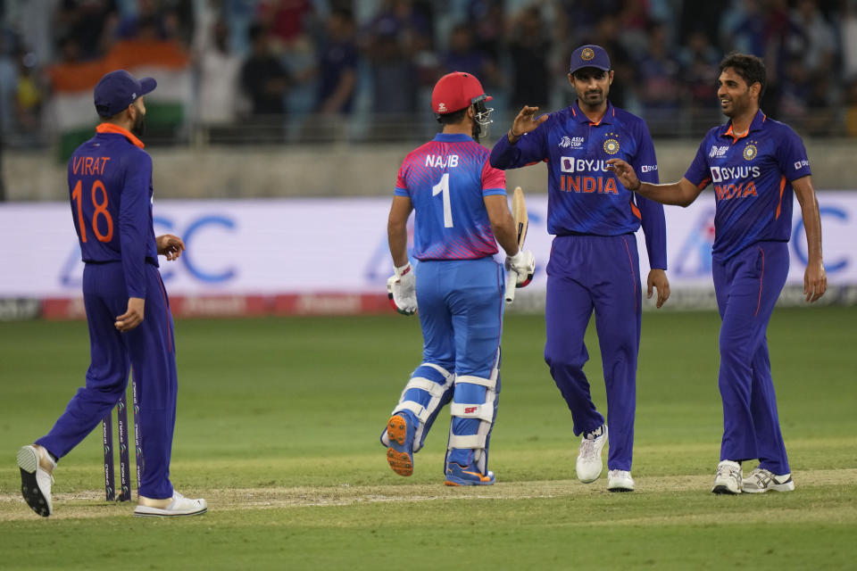 India's Bhuvneshwar Kumar, right, celebrates with teammates the dismissal of Afghanistan's Najibullah Zadran, second left, during the T20 cricket match of Asia Cup between India and Afghanistan, in Dubai, United Arab Emirates, Thursday, Sept. 8, 2022. (AP Photo/Anjum Naveed)