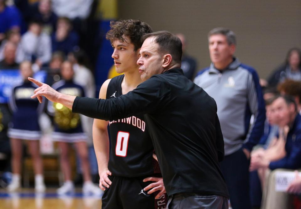 NorthWood head coach Aaron Wolfe talks with Ethan Wolfe (0) during the IHSAA Semi-State Saturday, Mar. 18, 2023 at Northside Gym in Elkhart.