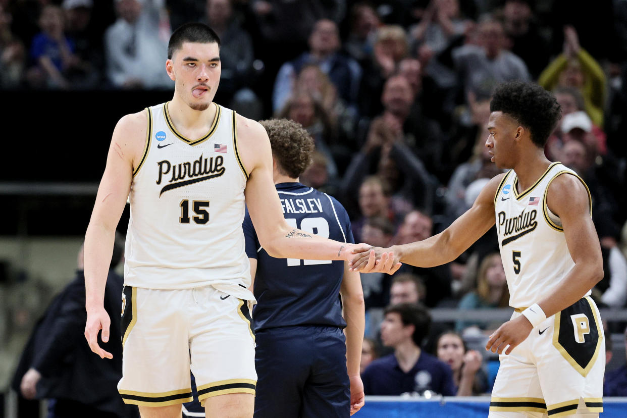 INDIANAPOLIS, INDIANA - MARCH 24: Zach Edey #15 and Myles Colvin #5 of the Purdue Boilermakers high five against the Utah State Aggies during the first half in the second round of the NCAA Men's Basketball Tournament at Gainbridge Fieldhouse on March 24, 2024 in Indianapolis, Indiana. (Photo by Andy Lyons/Getty Images)