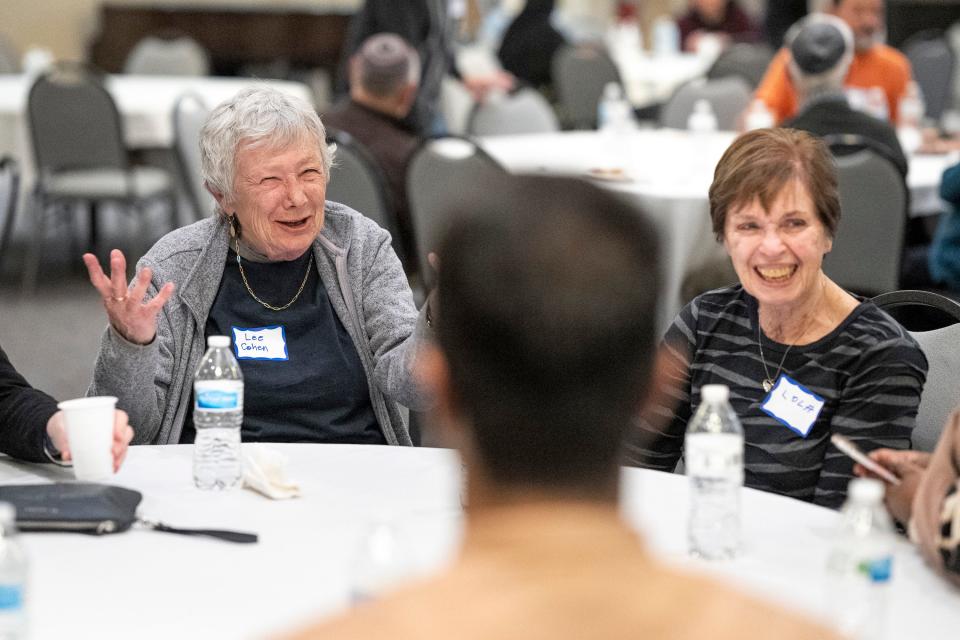 Dr. Lee Cohen, left, laughs wile dining with her friend Lola Steinhart and the rest of her table during an interfaith dinner in association with the Noor Islamic Center and the Congregation Tifereth Israel synagogue in Columbus on March 30. “This is a long tradition, and it’s lovely to be part of it and I would certainly return and be more involved,”