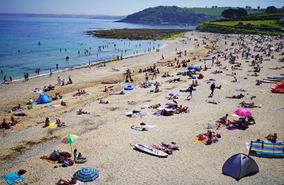 People enjoy the sun on Gyllyngvase Beach near Falmouth in Cornwall (Aaron Chown/PA) (PA Wire)