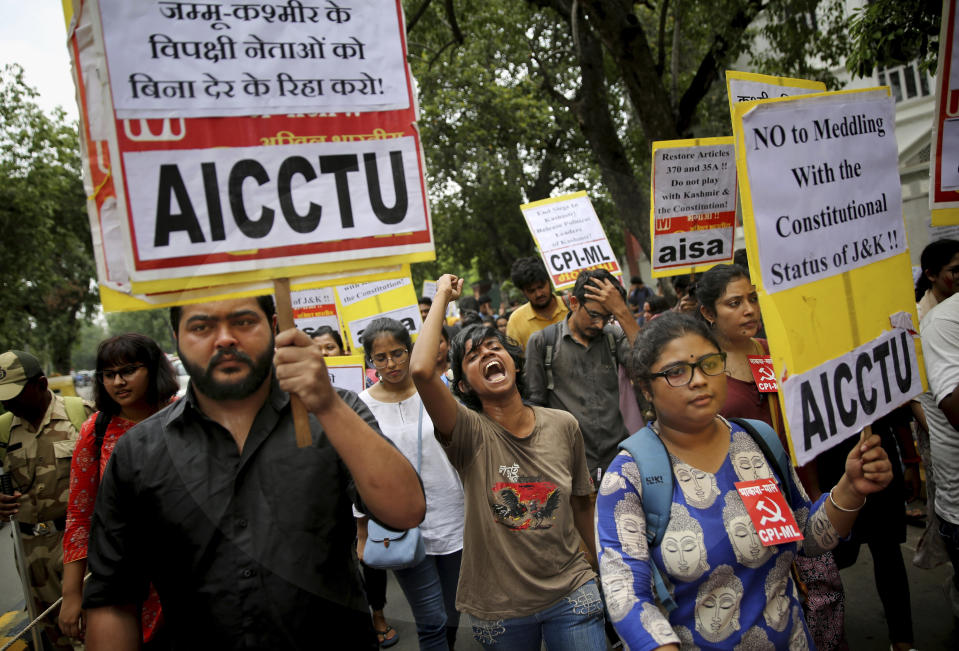 Indian activists and others shout slogans during a protest against Indian government revoking Kashmir's special constitutional status in New Delhi, India, Wednesday, Aug. 7, 2019. India's Hindu nationalist-led government has used a presidential order to revoke the special constitutional status of Muslim-majority Jammu and Kashmir state. It also had a bill passed to downgrade Jammu and Kashmir into a union territory instead of a state and turn a third region of the state, Ladakh, into a separate union territory. (AP Photo/Altaf Qadri)