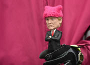 <p>A protester, holding a Donald Trump doll wearing a pink cap, marches in Washington, DC, during the Womens March on January 21, 2017. (ROBYN BECK/AFP/Getty Images) </p>