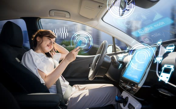 A woman sits in a connected car.