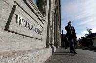 A delegate arrives before a meeting at the World Trade Organization (WTO) in Geneva