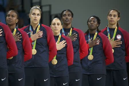 2016 Rio Olympics - Basketball - Final - Women's Gold Medal Game USA v Spain - Carioca Arena 1 - Rio de Janeiro, Brazil - 20/8/2016. Tamika Catchings (USA) of USA, Elena Delle Donne (USA) of USA, Diana Taurasi (USA) of USA, Sylvia Fowles (USA) of USA, Tina Charles (USA) of USA and Brittney Griner (USA) of USA (L to R) stand for the playing of the U.S. National Anthem during the medal presentation ceremony for the women's basketball top finishers. REUTERS/Shannon Stapleton