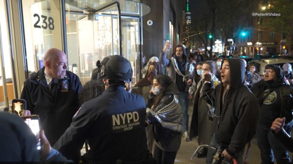 Officers could be seen swatting protesters’ hands away before McCarthy pushed through the crowd and led the officers around the side of the building to look for another entrance. Peter Hambrecht