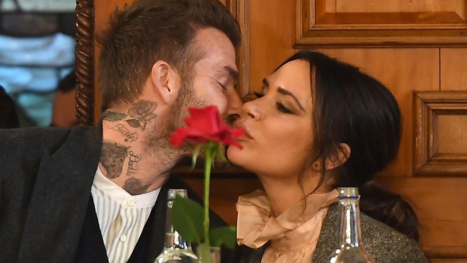 David Beckham kisses Victoria at the dinner table