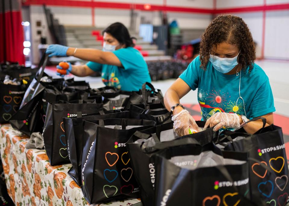 Ingrid Lopez, an office assistant at the Friendly House, packs food bags full with vegetables Sept. 10, 2020. In honor of Hunger Action Day, Stop & Shop associates from Worcester area stores joined Friendly House staff to fill 1,000 bags with nearly five tons of donated produce to be given out to those in need.