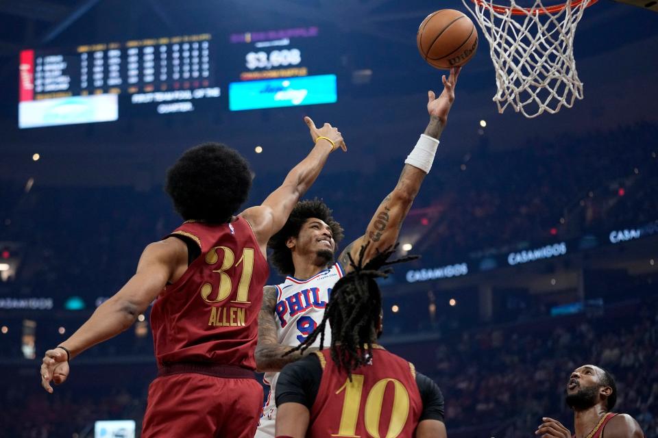 Philadelphia 76ers guard Kelly Oubre Jr. (9) shoots in front of Cleveland Cavaliers center Jarrett Allen (31) and guard Darius Garland (10) in the first half of an NBA basketball game, Monday, Feb. 12, 2024, in Cleveland. (AP Photo/Sue Ogrocki)