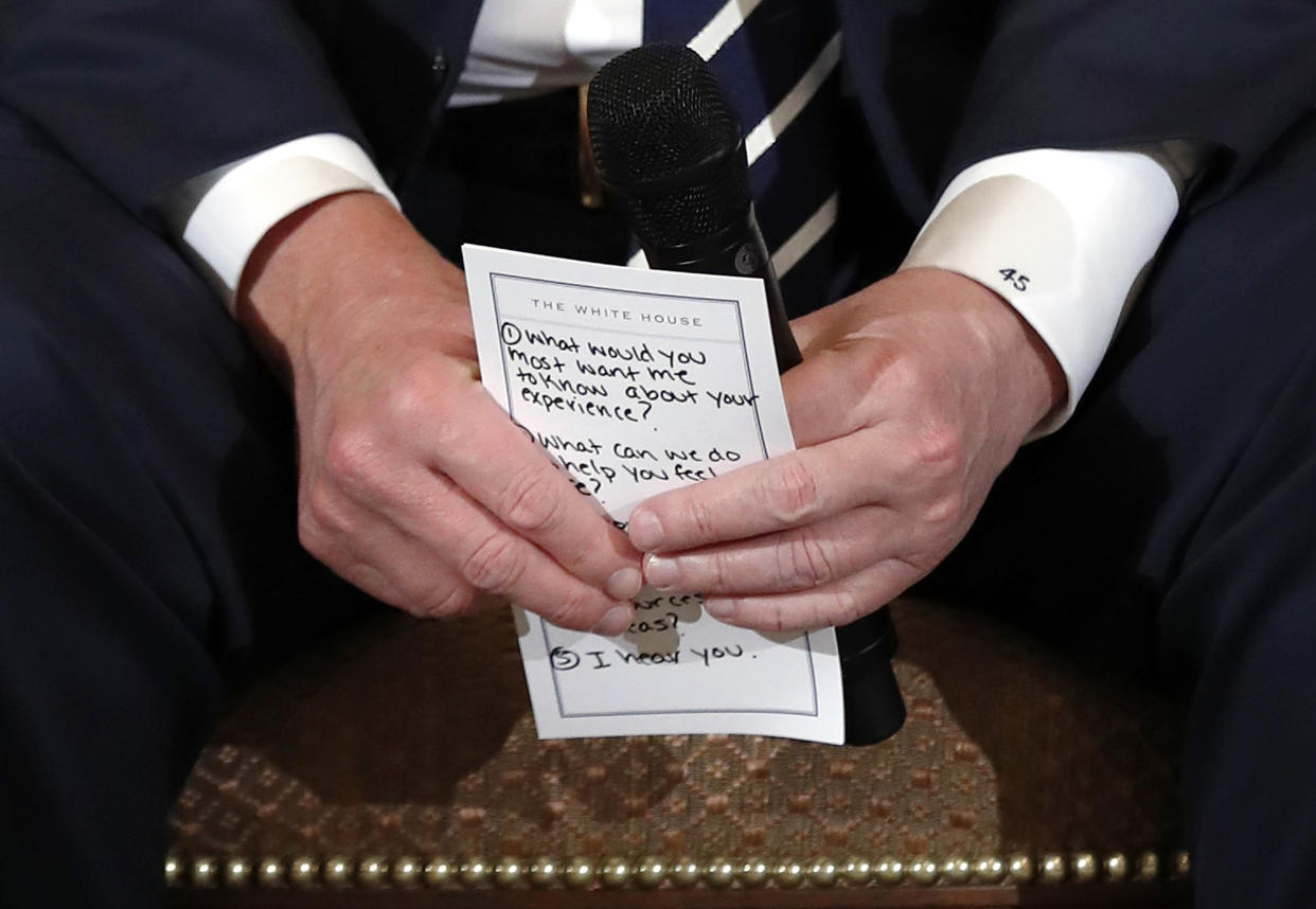 President Trump holds notes, including a reminder to say “I hear you,” during a Wednesday listening session with high school students and teachers affected by school shootings. (Photo: Carolyn Kaster/AP)