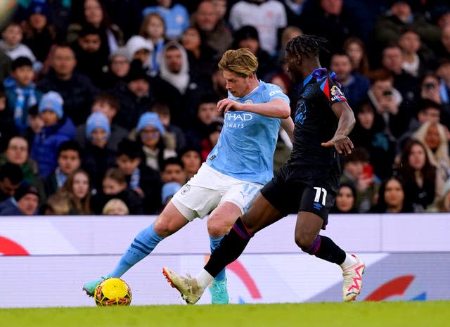 Kevin De Bruyne, left, takes on Huddersfield’s Brahima Diarra