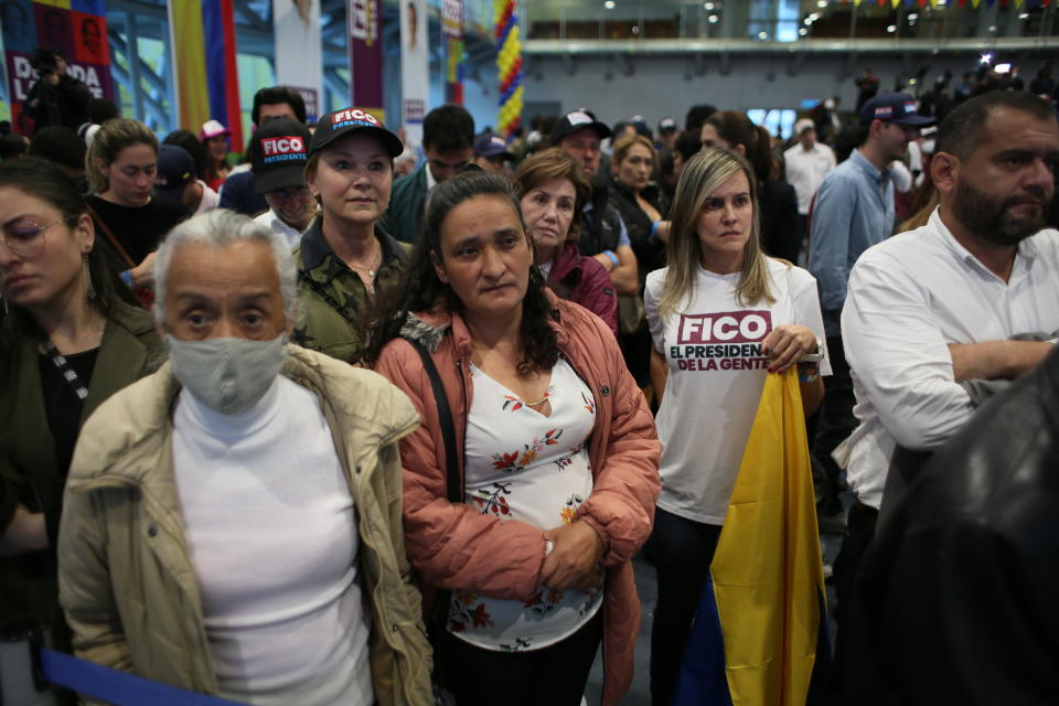 Supporters of Federico Gutierrez, presidential candidate with the Team Colombia coalition, listen to him speak on election night in Bogota, Colombia, Sunday, May 29, 2022. Gutierrez did not advance to the June runoff. (AP Photo/Leonardo Munoz)