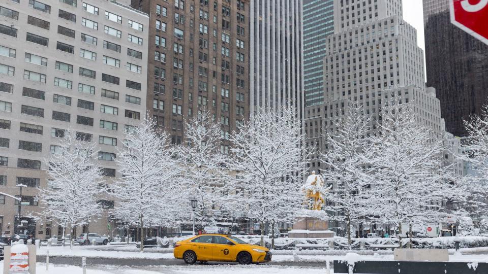 Yellow taxi on snow covered street in New York City