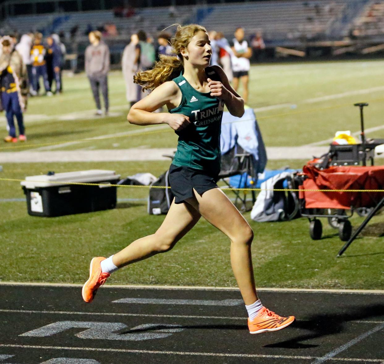 Trinity at Greenlawn freshman Audrey Lee crosses the finish like to win the 3,200-meter run at the South Bend city track and field meet Thursday, April 25, 2024, at Saint Joseph High School.