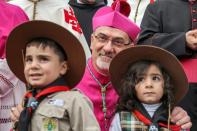 Pierbattista Pizzaballa, the Latin Patriarch of Jerusalem, poses with children outside the Church of Nativity in Bethlehem (AFP/JAAFAR ASHTIYEH)