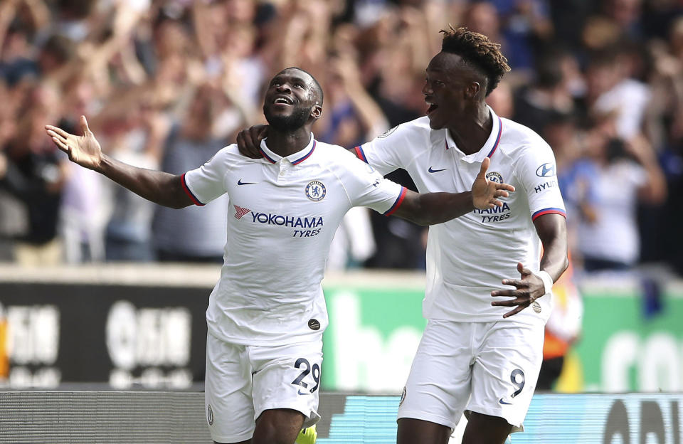 Chelsea's Fikayo Tomori, left, celebrates scoring his side's first goal of the game with teammate Tammy Abraham during their English Premier League soccer match against Wolverhampton Wanderers at Molineux, Wolverhampton, England, Saturday, Sept. 14, 2019. (Nick Potts/PA via AP)