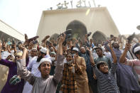 A group of protestors shout slogans and wave shoes after Friday prayers at Baitul Mokarram mosque in Dhaka, Bangladesh, Friday, March 26, 2021. Witnesses said violent clashes broke out after one faction of protesters began waving their shoes as a sign of disrespect to Indian Prime Minister Narendra Modi, and another group tried to stop them. Local media said the protesters who tried to stop the shoe-waving are aligned with the ruling Awami League party. The party criticized the other protest faction for attempting to create chaos in the country during Modi’s visit. (AP Photo/Mahmud Hossain Opu)