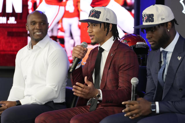 Houston Texans head coach DeMeco Ryans, left, looks as Texans' first round draft pick quarterback C.J. Stroud, center, speaks alongside linebacker Will Anderson Jr. during an NFL football press conference, Friday, April 28, 2023, in Houston. (AP Photo/Kevin M. Cox)