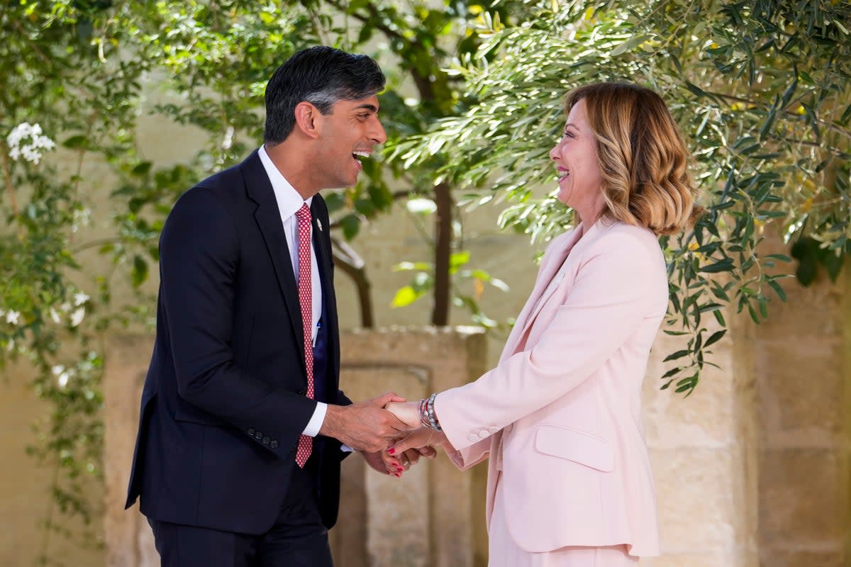 Britain's Prime Minister Rishi Sunak is welcomed by Italian Prime Minister Giorgia Meloni on the first day of the 2024 G7 summit at Borgo Egnazia, Italy, on June 13 (AP)