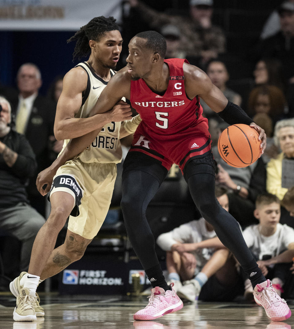 Rutgers forward Aundre Hyatt (5) moves around Wake Forest guard Hunter Sallis (23) during the first half of an NCAA college basketball game Wednesday, Dec. 6, 2023, in Winston-Salem, N.C. (Allison Lee Isley/The Winston-Salem Journal via AP)