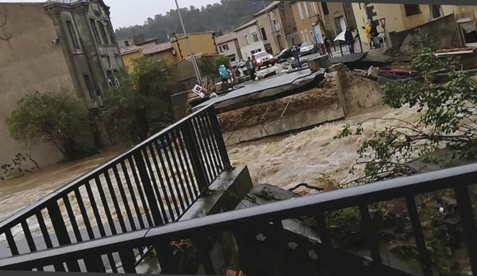 This photo provided by Stephane Jourdain, after a torrent of water ripped out the bridge in Villegailhenc, southern France, Monday Oct. 15, 2018. Flash floods have left several people dead in southwest France, with roads swept away and streams become raging torrents as the equivalent of several months of rain fell overnight, authorities said Monday. (AP Photo/Stephane Jourdain)