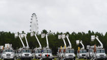 Utility trucks are staged near the Orange County Convention center, ahead of Hurricane Ian, Wednesday, Sept. 28, 2022, in Orlando, Fla. (AP Photo/John Raoux)