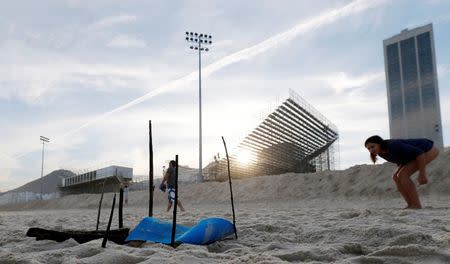 A woman looks at a part of a mutilated body near the construction site of the beach volleyball venue for 2016 Rio Olympics on Copacabana beach in Rio de Janeiro, Brazil. REUTERS/Sergio Moraes