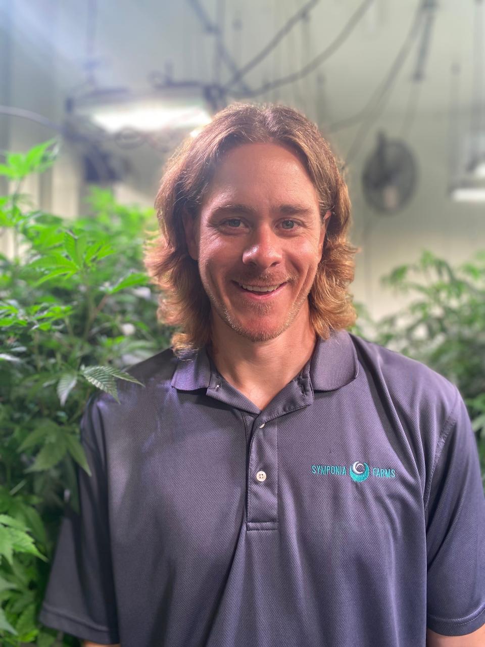 Scott Hershberger stands inside a grow room at Symponia Farms in Battle Creek on Wednesday, Aug. 3, 2022. Hershberger is a disabled veteran and one of three veterans who own the growing, processing and provisioning center.