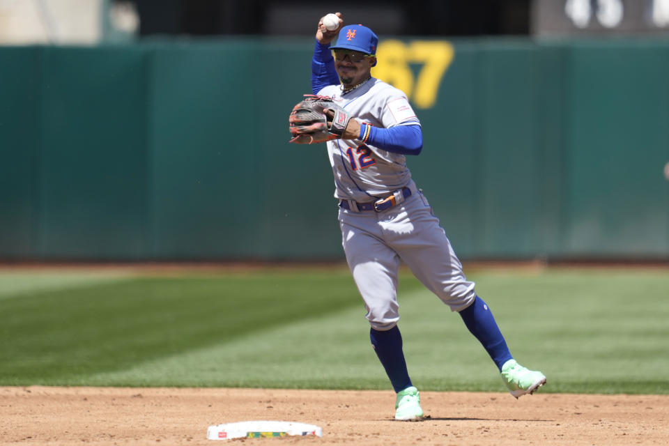 New York Mets shortstop Francisco Lindor (12) throws out Oakland Athletics' Esteury Ruiz at first base during the third inning of a baseball game in Oakland, Calif., Sunday, April 16, 2023. (AP Photo/Jeff Chiu)