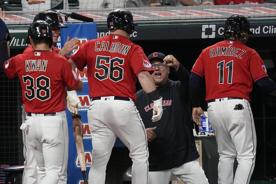 Cleveland Guardians manager Terry Francona, center, greets Jose Ramirez (11), Kole Calhoun (56) and Steven Kwan (38) in the dugout after Calhoun hit a three-run home run against the Los Angeles Dodgers during the seventh inning of a baseball game Tuesday, Aug. 22, 2023, in Cleveland. (AP Photo/Sue Ogrocki)