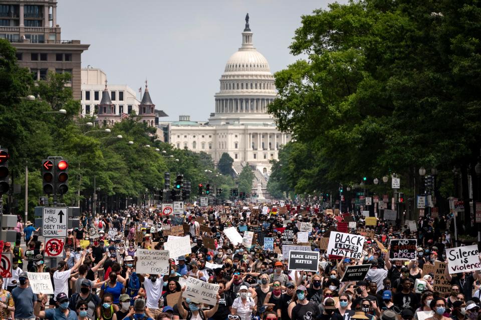 Demonstrators marched down Pennsylvania Avenue during a protest against police brutality and racism on June 6, 2020, in Washington, DC. This was the 12th day of protests, with people descending on the city to peacefully demonstrate in the wake of the death of George Floyd, a black man who was killed in police custody in Minneapolis on May 25.