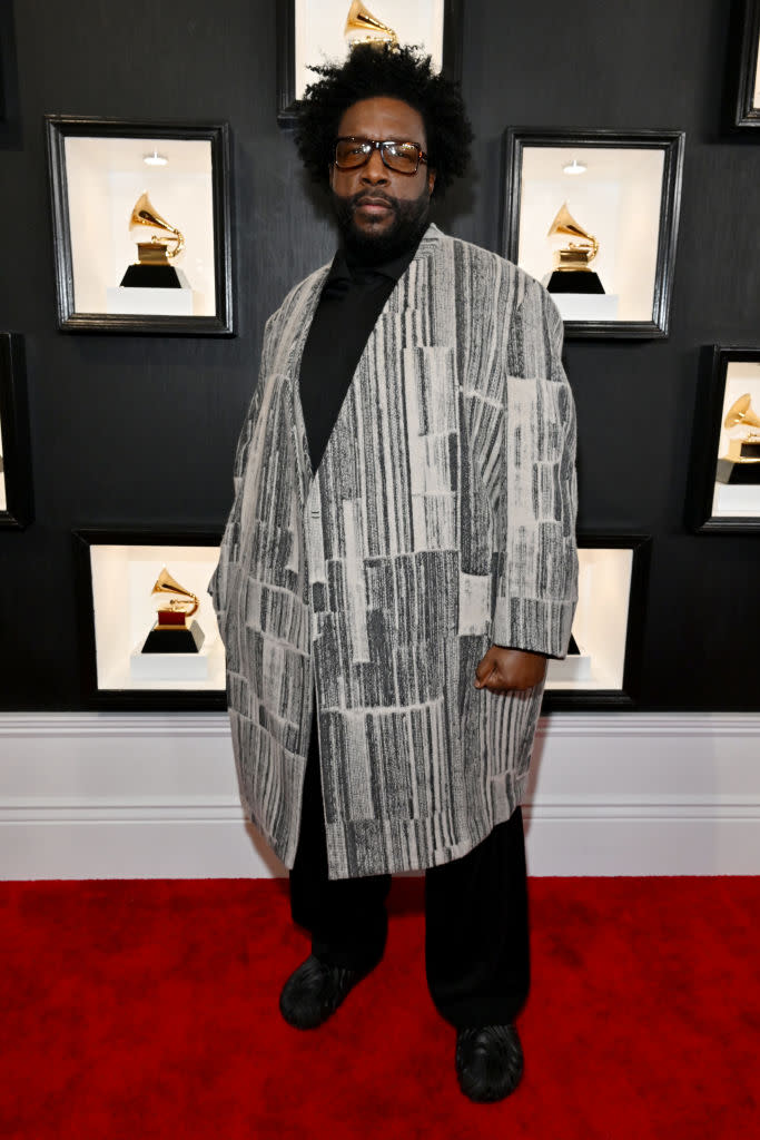 Questlove in charcoal textile coat.