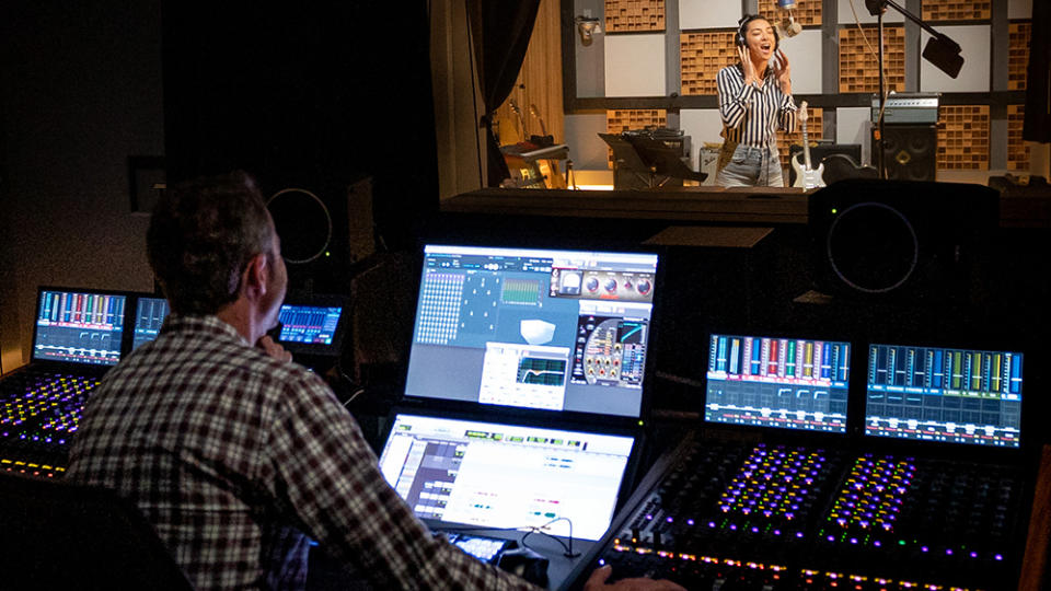 A sound engineer using Dolby Atmos Music on a studio mixer