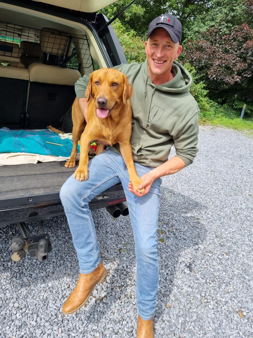 Rowan Boddington, 41, with his 18-month-old red Labrador Rufus. (SWNS)