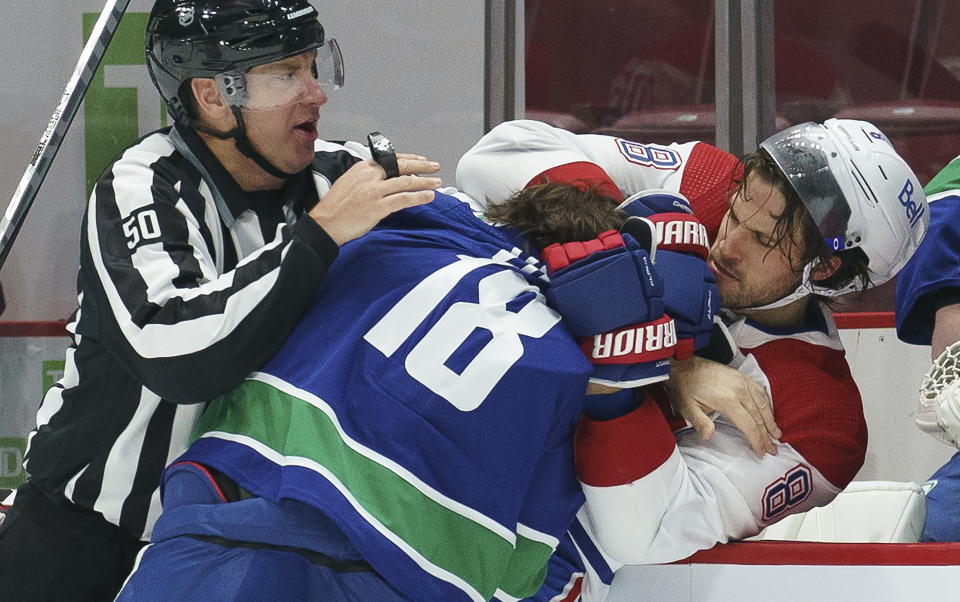 Vancouver Canucks right wing Jake Virtanen (18) tussles with Montreal Canadiens defenseman Ben Chiarot (8) during the first period of an NHL hockey game Thursday, Jan. 21, 2021, in Vancouver, British Columbia. (Jonathan Hayward/The Canadian Press via AP)