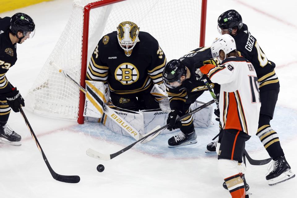 Boston Bruins' Charlie Coyle (13) attempts to clear the puck from Anaheim Ducks' Troy Terry (19) during the first period of an NHL hockey game Thursday, Oct. 26, 2023, in Boston. (AP Photo/Michael Dwyer)