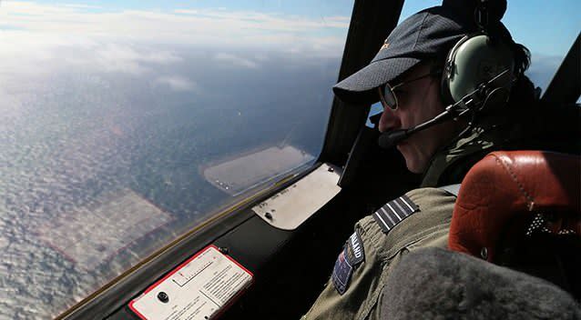 Royal New Zealand Air Force P-3 Orion's captain, Wing Comdr. Rob Shearer watches out of the window of his aircraft while searching for the missing Malaysia Airlines Flight MH370 in the southern Indian Ocean. Photo: AP.