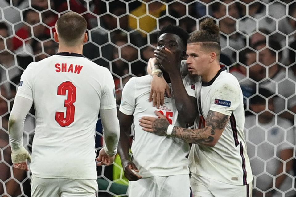 Bukayo Saka (centre) being consoled by his England teammates after missing in the penalty shootout during the Euro 2020 final.