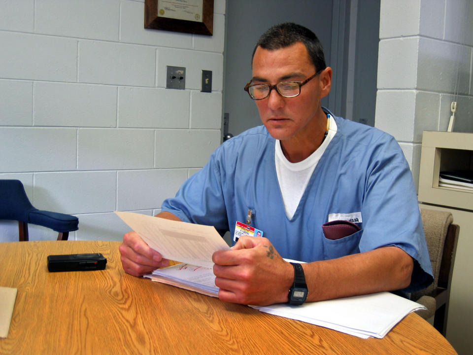 FILE - In this undated image, Frank Gable looks over papers at the Okaloosa Correctional Institution in Crestview, Fla. Gable, who spent nearly three decades in prison for the 1989 killing of Oregon’s prisons director, has been granted his full freedom. U.S. Magistrate Judge John V. Acosta ordered the Marion County murder indictment against Gable be dismissed on Monday, May 8, 2023, and prohibited the state from retrying him in the death of Oregon prison chief Michael Francke, The Oregonian/OregonLive reported. Gabe, who left prison in 2019, has remained on federal supervision. (Les Zaitz/The Oregonian via AP, File)