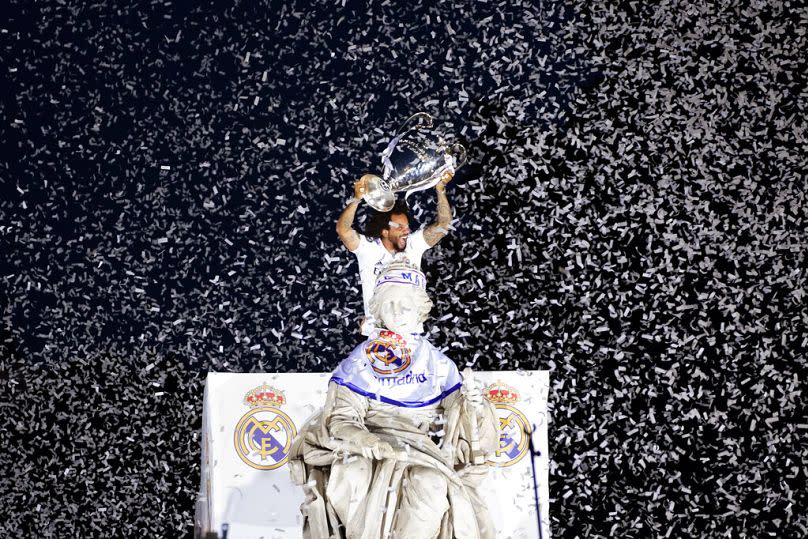 Real Madrid player Marcelo holds the Champions League trophy at Cibeles Square in front of the City Hall in Madrid, May 2022