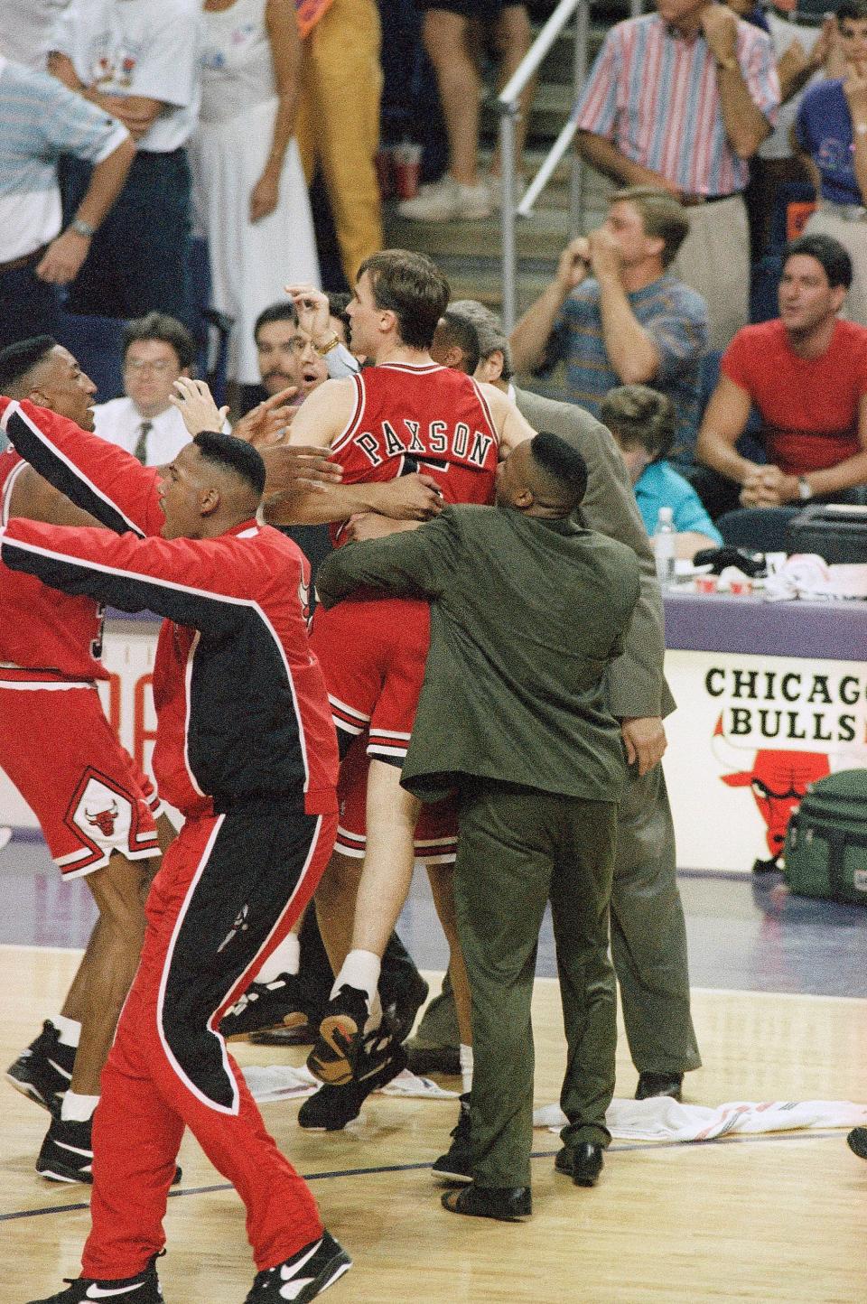 Chicago's John Paxson gets mobbed after his 3-point shot with 3.9 seconds left in the game over the Suns in Game 6 of the 1993 NBA Finals.