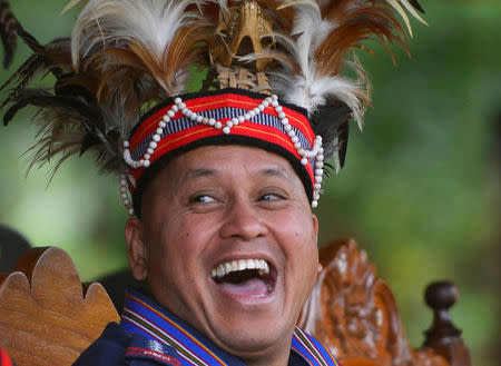 Philippine National Police Chief General Ronald "Bato" Dela Rosa laughs while wearing a local Igorot tribe headdress during a visit at police Camp Dangwa, Benguet province in northern Philippines September 2, 2016. REUTERS/Ezra Acayan