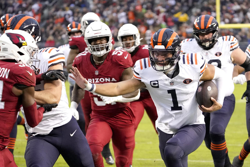 Chicago Bears quarterback Justin Fields (1) carries the ball during the first half of an NFL football game against the Arizona Cardinals, Sunday, Dec. 24, 2023, in Chicago. (AP Photo/David Banks)