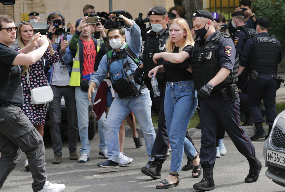 Police officers detain a protester during a rally to support Ivan Safronov near the Lefortovo prison in Moscow, Russia, Monday, July 13, 2020. Safronov, an ex-journalist who worked as an adviser to the director of Russia's state space corporation has been arrested and jailed on charges of passing military secrets to Czech intelligence. Ivan Safronov wrote about military and security issues before becoming an adviser to the head of Roscosmos. (AP Photo/Alexander Zemlianichenko)