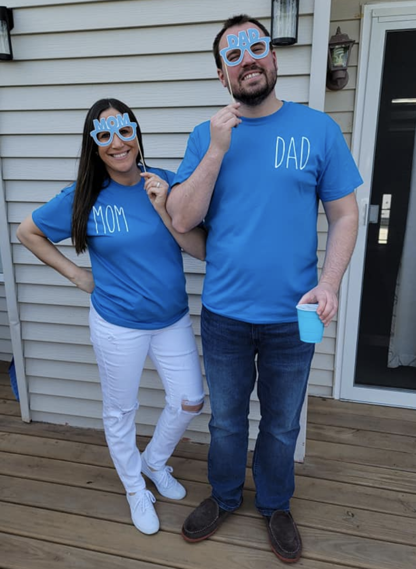 Mr and Mrs Evers wearing 'dad' and 'mum' shirts at their baby shower.