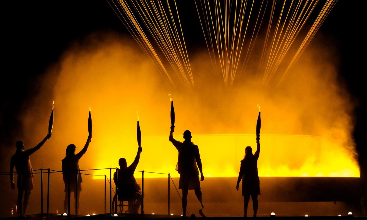 <span>Torchbearers Charles Antoine Kouakou, Fabien Lamirault, Elodie Lorandi, Nantenin Keita and Alexis Hanquinquant gesture after lighting the Cauldron in Paris.</span><span>Photograph: David Ramos/Getty Images</span>