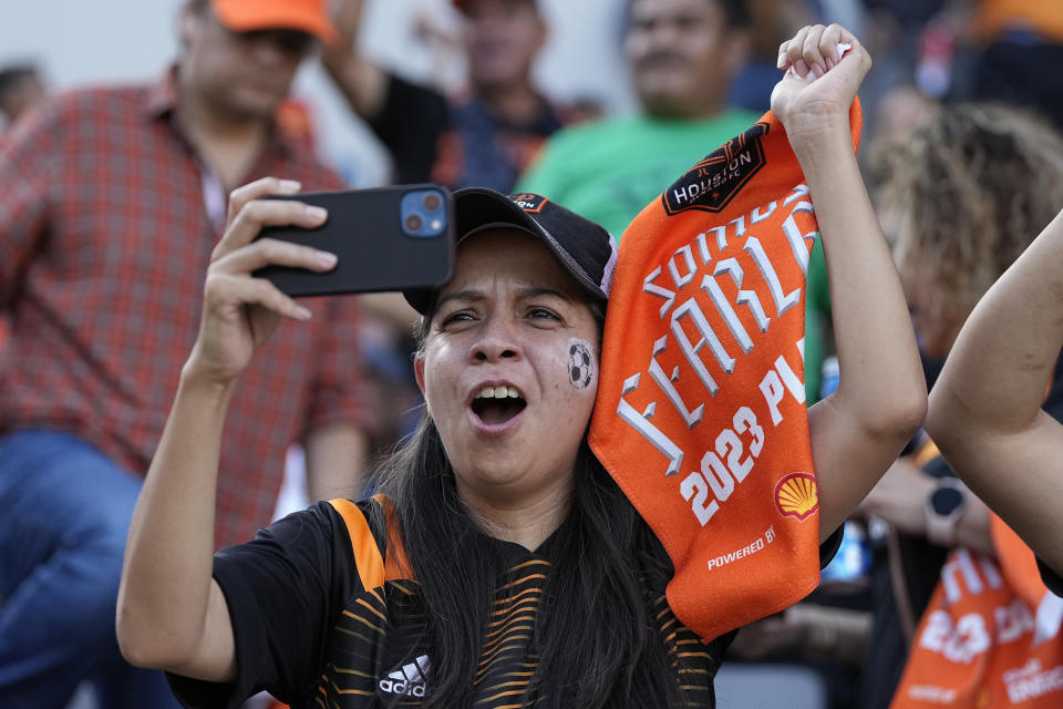 A Houston Dynamo fan cheers before an MLS playoff soccer match against Real Salt Lake, Sunday, Oct. 29, 2023, in Houston. (AP Photo/Kevin M. Cox)